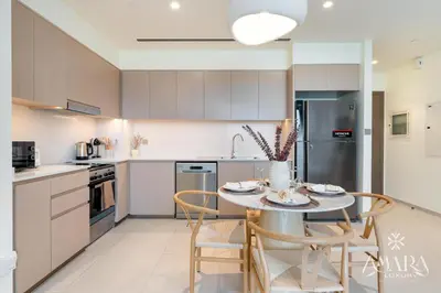 a kitchen with a table and chairs in a room at Grande Luxury, Burj Khalifa & Fountain View in Dubai