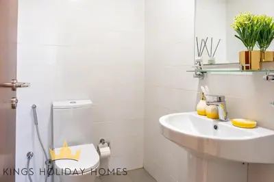 a white bathroom with a sink and a toilet at Royal Suites Dunya Tower Burj Khalifa ST in Dubai