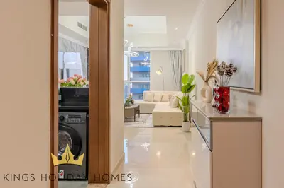 a living room with a washer and dryer at Royal Suites Dunya Tower Burj Khalifa ST in Dubai
