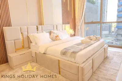 a large white bed in a room with a window at Royal Suites Dunya Tower Burj Khalifa ST in Dubai