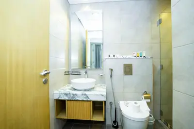 a bathroom with a sink and a toilet and a mirror at High-Floor 2BR - Aykon City 2BR in Business Bay in Dubai
