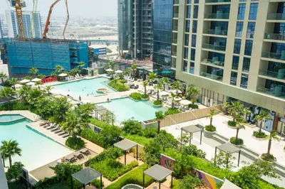 an aerial view of a pool in a city with tall buildings at High-Floor 2BR - Aykon City 2BR in Business Bay in Dubai