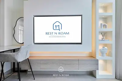 a living room with a tv on a wall at Brand New 1BR Near Parks and Mall JVC in Dubai