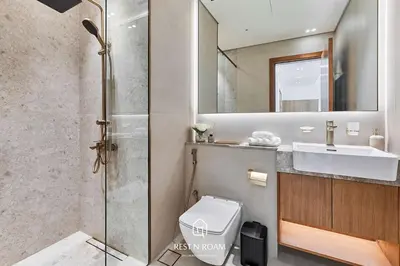 a bathroom with a sink and a toilet and a mirror at High Floor 1BR - Near Parks and Mall - JVC in Dubai