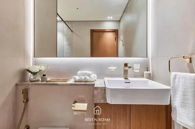 a bathroom with a sink and a mirror at High Floor 1BR - Near Parks and Mall - JVC in Dubai