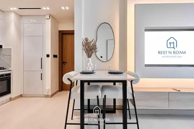 a dining room with a table and a mirror at High Floor 1BR - Near Parks and Mall - JVC in Dubai