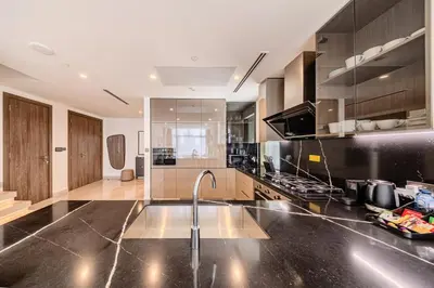 a kitchen with a sink and a faucet at Peninsula Five 3BD Duplex with Lake view, For 9 in Dubai