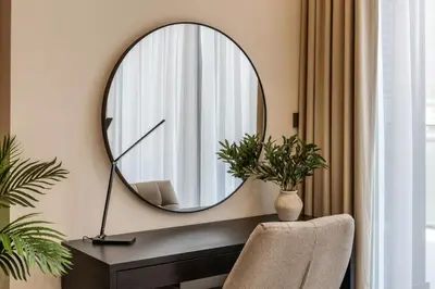 a mirror on a wall above a desk with a chair at Peninsula Five 3BD Duplex with Lake view, For 9 in Dubai