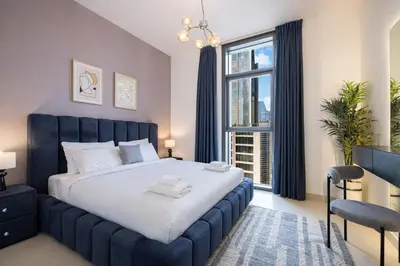 a bedroom with a large bed and a large window at Exceptional 2 Bedroom Apartment! High Floor! Amazing Rooftop! Burj Crown by Emaar in Dubai