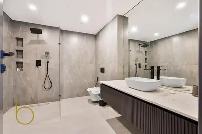 a bathroom with two sinks and a shower at Bookable - Penthouse 5,000sqft by Downtown Dubai in Dubai