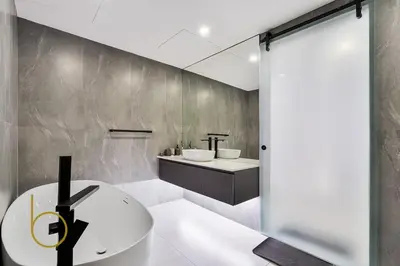 a bathroom with a white sink and a mirror at Bookable - Penthouse 5,000sqft by Downtown Dubai in Dubai