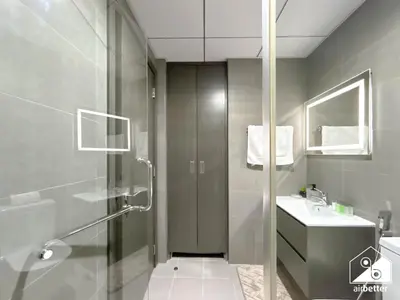 a bathroom with a shower and a sink at Urban Escape Studio l Pool, Gym & Stylish Living in Dubai