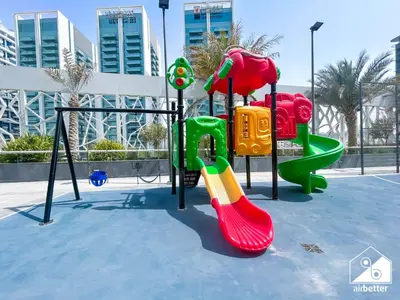a playground with a slide at Urban Escape Studio l Pool, Gym & Stylish Living in Dubai