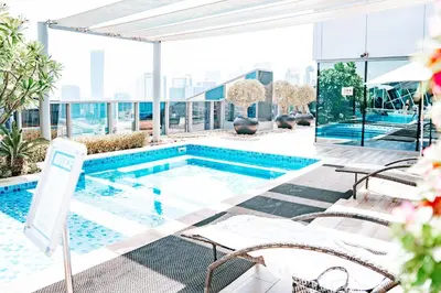a swimming pool on the roof of a building at Urban 1BR Stay, Walk to Downtown & Canal in Dubai
