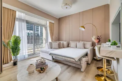 a bedroom with a white bed and a large window at Exec 1Bed with Balcony&Pool, 10mins to Downtown in Dubai