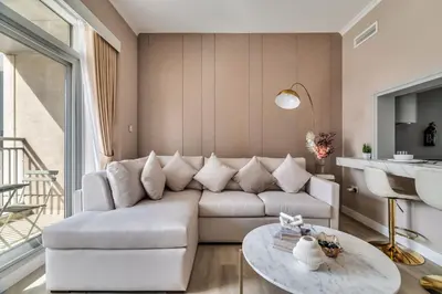 a living room with a white couch and a table at Exec 1Bed with Balcony&Pool, 10mins to Downtown in Dubai