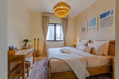 a bedroom with a large bed and a desk at Oasis in the heart of Downtown in Dubai