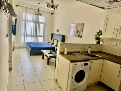 a kitchen and living room with a washing machine at Not far from metro and WTC in Dubai