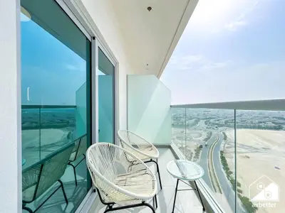 two chairs and a table on a balcony at Your Fav Studio Getaway l Pool, Gym & Parking! in Dubai