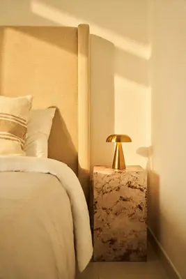 a bedroom with a bed and a lamp on a night stand at Luxury 58th Floor Seaview 2BR - Paramount Midtown - 6 Guests - 64F Pool Access & Burj View in Dubai