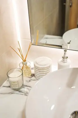 a bathroom counter with a sink and a mirror at Luxury 58th Floor Seaview 2BR - Paramount Midtown - 6 Guests - 64F Pool Access & Burj View in Dubai