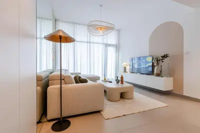 a living room with a couch and a table at Hills Parkhouse - Pool Gym Parks Mall and Burj Khalifa View in Dubai