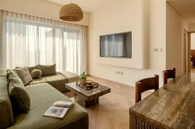 a living room with a couch and a table at Seraya Residences at Burj Royale in Dubai
