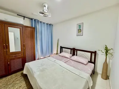 a bedroom with a bed with two pink pillows at Spacious & cozy home 2-Bedroom in Dubai