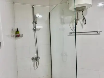 a shower with a glass door in a bathroom at Spacious & cozy home 2-Bedroom in Dubai