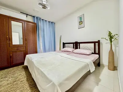 a bedroom with a bed with two pink pillows at Spacious & cozy home 2-Bedroom in Dubai