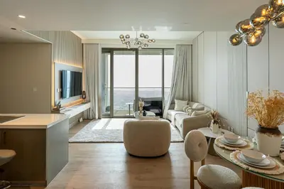 a living room with a couch and a table at Serenity Suite Stylish 2BR Pool & Fitness Perks in Dubai