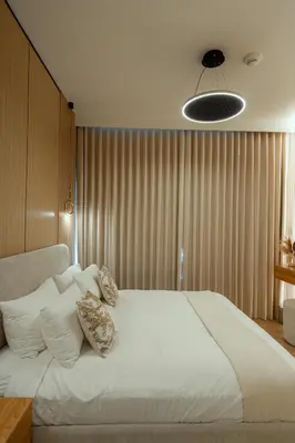 a bedroom with a large white bed with pillows at Serenity Suite Stylish 2BR Pool & Fitness Perks in Dubai