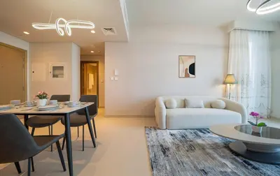a living room with a couch and a table at Luxurious 1BR Apartment in Harbour Gate in Dubai