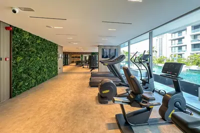 a gym with treadmills and cardio equipment in a building at Brand New Studio with Pool View in The Grove by Iman, Dubai Hills in Dubai