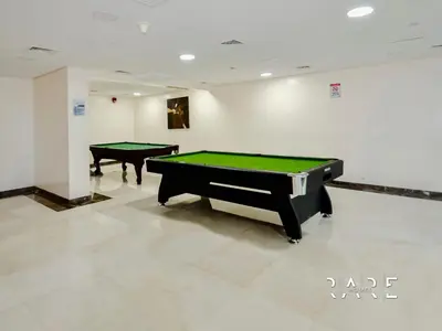 two billiard tables in a room with a pool table at Rare Holiday Homes - Near City Center Ma'eisem - Lake view - Crescent Tower C - R806 - IMPZ in Dubai