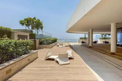 a row of white chairs sitting on top of a building at Airstay - Minimalist 1BR - EMAAR Beachfront - Monthly Offer Available in Dubai
