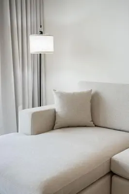 a couch and a lamp in a room at Airstay - Minimalist 1BR - EMAAR Beachfront - Monthly Offer Available in Dubai