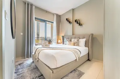 a bedroom with a bed and a large window at Facing the Dubai Water Canal 1BR, Minutes from Metro with Easy Downtown Access, Zada Tower, Business Bay by Deluxe Holiday Homes in Dubai