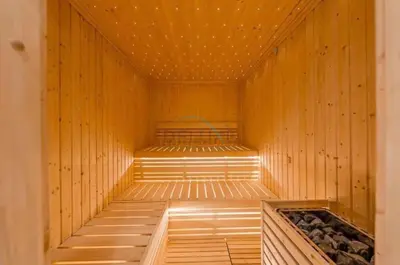 a wooden sauna with a bench in the middle at Facing the Dubai Water Canal 1BR, Minutes from Metro with Easy Downtown Access, Zada Tower, Business Bay by Deluxe Holiday Homes in Dubai