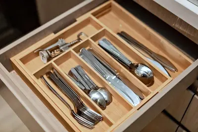 a drawer with silver utensils in a cabinet at Burj View Stylish 3BR with Maids Room in Act One Tower Downtown in Dubai