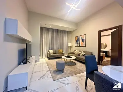 a living room with a couch and a table at Chic 1BR in Business Bay l Pool, Gym & Sauna in Dubai