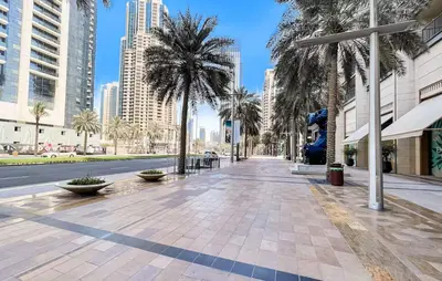 a street in a city with palm trees and buildings at Vogue Downtown The Lofts near Burj Khalifa and Dubai Mall, Two Bedroom Apartment with Balcony and City Skyline View, Access to all Amenities in Dubai