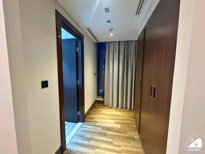 a hallway with a door leading to a room at Stylish 1BR Stay l Rooftop Pool, Sauna & Gym in Dubai