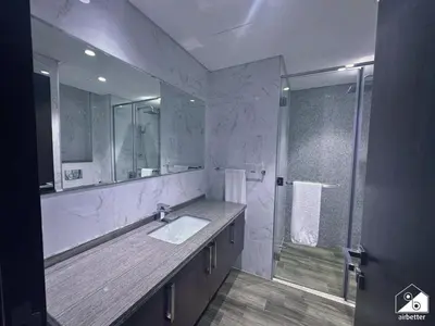 a bathroom with a sink and a shower at Stylish 1BR Stay l Rooftop Pool, Sauna & Gym in Dubai