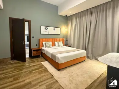 a bedroom with a large bed and a window at Stylish 1BR Stay l Rooftop Pool, Sauna & Gym in Dubai