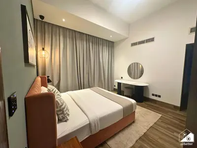 a hotel room with a bed and a table at Stylish 1BR Stay l Rooftop Pool, Sauna & Gym in Dubai