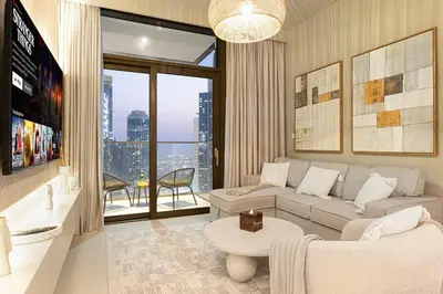 a living room with a couch and a table at Mahogany 15 - 1BR 4 Guests - Walk to Burj Khalifa in Dubai