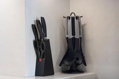 a group of knives in a holder on a wall at Mahogany 15 - 1BR 4 Guests - Walk to Burj Khalifa in Dubai