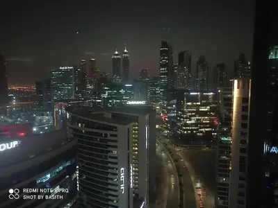 a view of a city at night with at Modern Monastery 1 BR Business Bay in Dubai