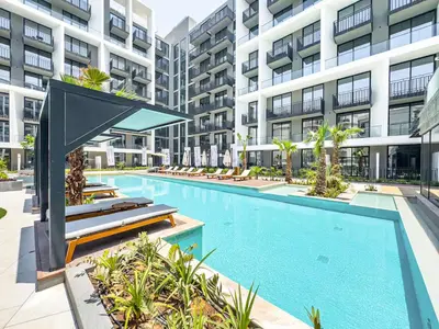an image of a swimming pool in a building at Modern Studio - Pool, Gym & Padel in Dubai